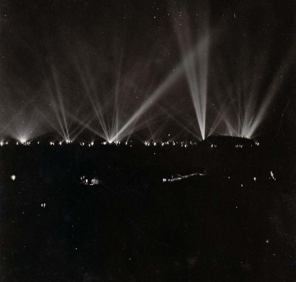 Black and white photograph of searchlights over Panama Bay and the Canal Zone during the night. World War II.