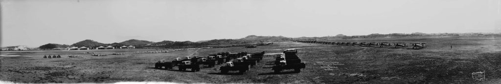 Vehicles and airplanes parked in rows on Albrook Field, Panama Canal Zone, in 1930.