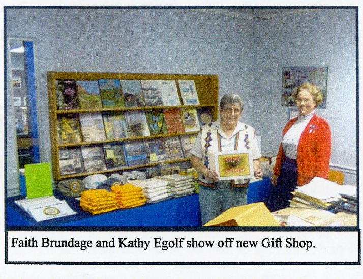 Two women stand in a gift shop.