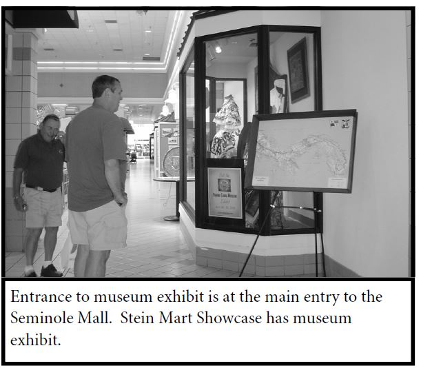 Photo of two men looking at the Panama Canal Museum traveling exhibit at the Seminole Mall.