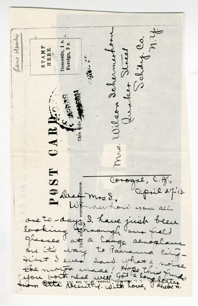 The handwritten note on the back of a postcard.