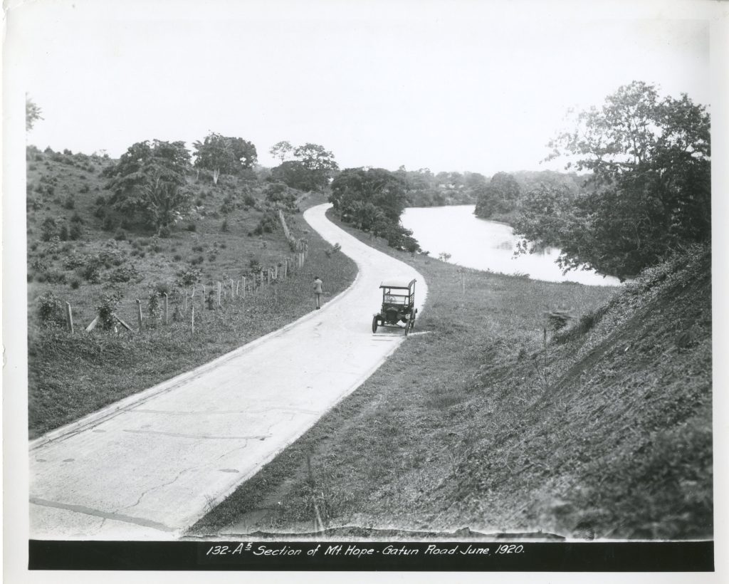 Car stopped on the side of a section of road between Mt. Hope and Gatun, Canal Zone. June 1920.