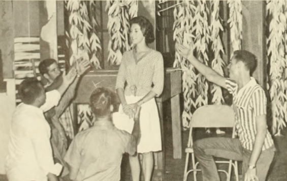 Photo of men on knees in front of a Jamboree Queen.