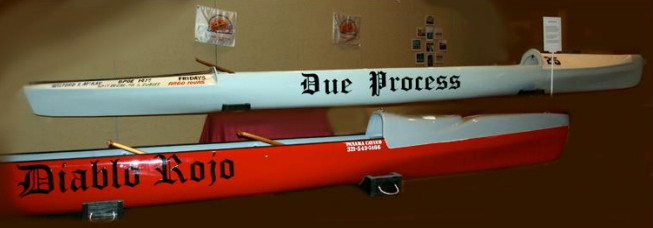 Photo of The Due Process and Diablo Rojo cayucos on display.